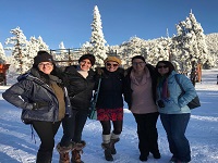EDP staff members in front of a snowy forest
