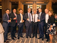 group of well dressed inviduals holding libations