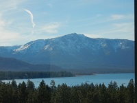 view of mountain, trees, and lake