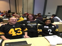 small group smiles while wearing favorite sports attire. Pittsburgh fans.